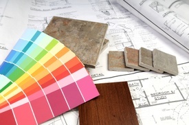 Image of paint shades palette, tile samples, wood samples, and a printed home remodeling blueprint.